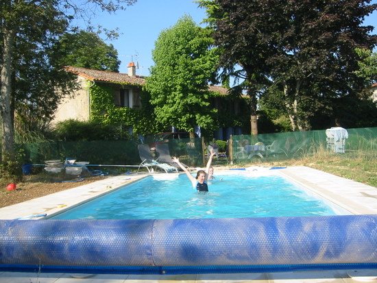 The pool is in front of the house